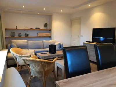 a living room with a couch and a table and chairs at Amsterdam Twiskehouse in Den Ilp