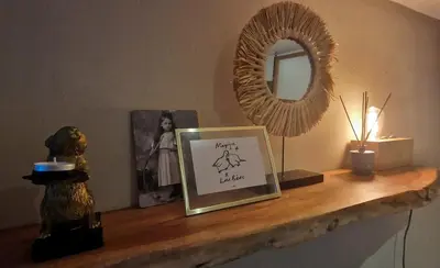 a shelf with a picture and a mirror and a lamp at Have a nice stay! - Le Souterrain in Noordwijk aan Zee