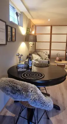 a living room with a table and a couch at Have a nice stay! - Le Souterrain in Noordwijk aan Zee
