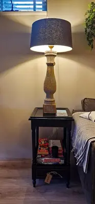 a lamp on a table next to a bed at Have a nice stay! - Le Souterrain in Noordwijk aan Zee