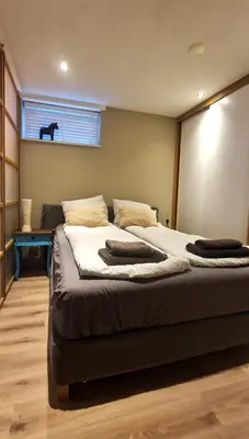 a bedroom with two beds and a window at Have a nice stay! - Le Souterrain in Noordwijk aan Zee