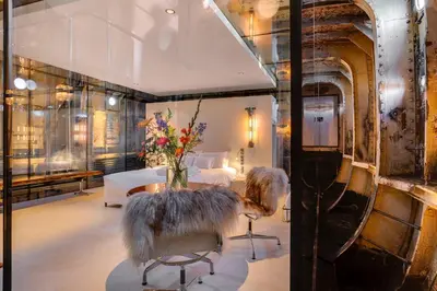 a room with two chairs and a table with flowers at Lightship Amsterdam in Amsterdam