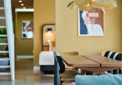 a dining room with a wooden table and chairs at Cityden BoLo District in Amsterdam