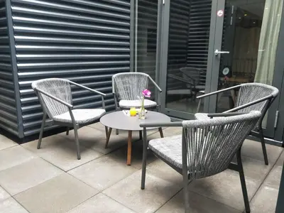 three chairs and a table on a patio at Cityden BoLo District in Amsterdam