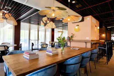 a dining room with a large wooden table and chairs at Cityden BoLo District in Amsterdam