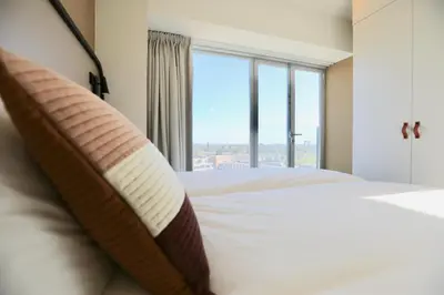 a bedroom with a bed with a large window at Cityden BoLo District in Amsterdam
