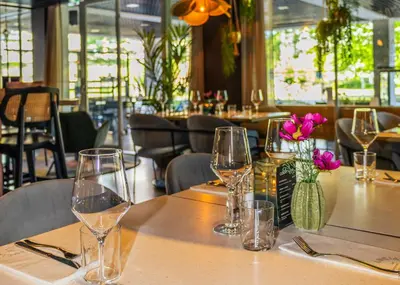 a table in a restaurant with wine glasses on it at Cityden BoLo District in Amsterdam