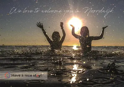 two girls in the water with the sun in their hands at Tiny Beachstudio Not Bookable in Noordwijk aan Zee