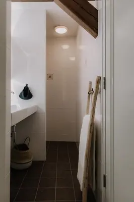 a bathroom with a sink and a towel at Brass Hotel in Utrecht