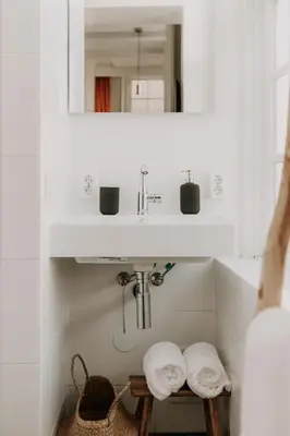 a bathroom with a sink and a mirror and towels at Brass Hotel in Utrecht