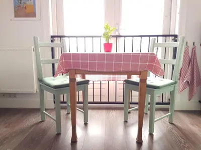 a table with two chairs and a table with a table cloth at B&B Alkmaars Toppunt in Alkmaar