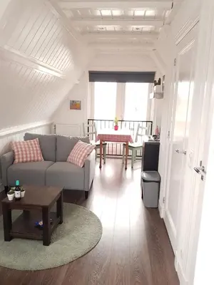 a living room with a couch and a table at B&B Alkmaars Toppunt in Alkmaar