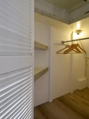 a room with white walls and a closet with wooden floors at Casa duna close to the beach, city centre, dunes and parking area in Zandvoort