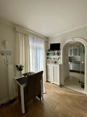 a living room with a table and a kitchen at Mevira Appartement in Zandvoort