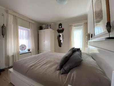 a bedroom with a large bed with pillows on it at Mevira Appartement in Zandvoort