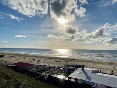 a view of a beach with people and the ocean at Mevira Appartement in Zandvoort