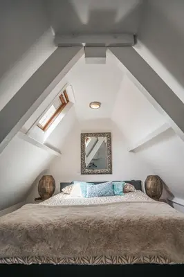 a bedroom with a large bed in the attic at Apartment Naarden-Vesting in Naarden