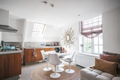 a kitchen and living room with a table and chairs at Apartment Naarden-Vesting in Naarden