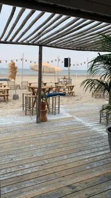 a wooden deck with picnic tables on the beach at Apartment Naarden-Vesting in Naarden