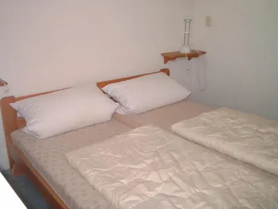 two beds sitting next to each other in a room at Ferienhaus Lisakowski in Warmenhuizen