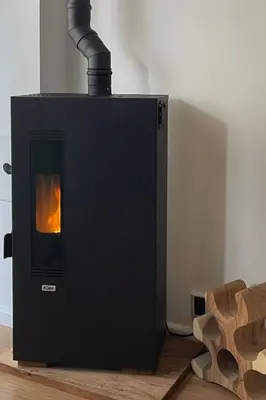 a black wood stove with a fire in it at Have a nice stay! - Pelican Dune near the beach in Noordwijk aan Zee