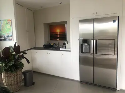 a kitchen with a stainless steel refrigerator at Have a nice stay! - La Casita Alta Free Parking in Noordwijk aan Zee