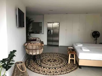 a living room with a bed and a rug at Have a nice stay! - La Casita Alta Free Parking in Noordwijk aan Zee