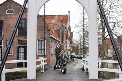 a man and a child riding a bike on a bridge at Ysbrantsz Boutique Hotel in Hoorn