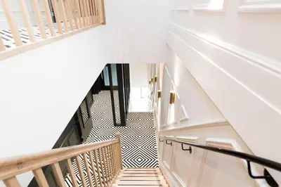 a staircase in a house with black and white flooring at Ysbrantsz Boutique Hotel in Hoorn