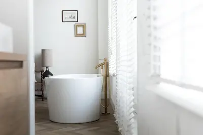 a white bathroom with a large tub in a room at Ysbrantsz Boutique Hotel in Hoorn