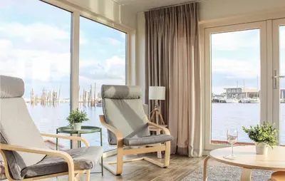 a living room with a view of the water at Cozy Ship In Aalsmeer With Wifi in Aalsmeer