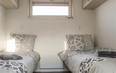 a bedroom with two beds and a window at Cozy Ship In Aalsmeer With Wifi in Aalsmeer