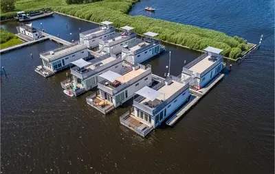 an aerial view of a row of houses in the water at Cozy Ship In Aalsmeer With Wifi in Aalsmeer