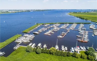 an aerial view of a marina with boats in the water at Cozy Ship In Aalsmeer With Wifi in Aalsmeer