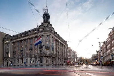 a large building with a flag in front of it at art'otel amsterdam, Powered by Radisson Hotels in Amsterdam