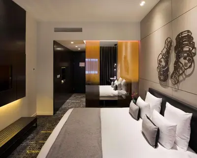 a hotel room with a bed and a mirror at art'otel amsterdam, Powered by Radisson Hotels in Amsterdam