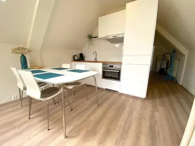 a kitchen with a table and chairs in a room at Zandvoort Central Apartment in Zandvoort