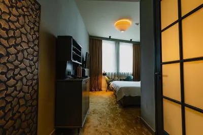 a hotel room with a bed and a television at Hotel Mai Amsterdam in Amsterdam