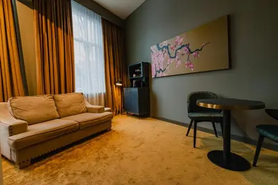 a living room with a couch and a table at Hotel Mai Amsterdam in Amsterdam