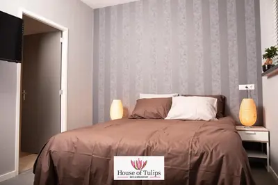 a bedroom with a bed with a house of turbines sign on it at House of Tulips in Hillegom