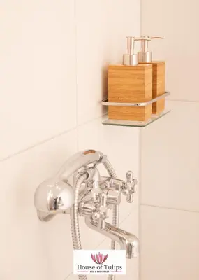 a bathroom sink with a faucet and a wooden box at House of Tulips in Hillegom
