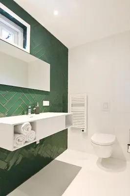 a bathroom with a white toilet and a green wall at Chalet Santpoort-Zuid in Santpoort-Zuid