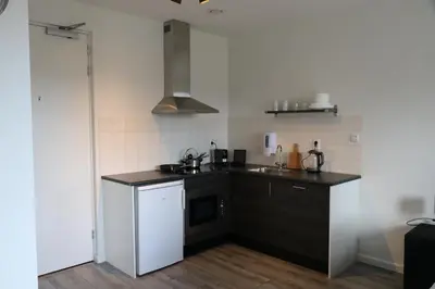 a small kitchen with a sink and a stove at Greenstay in Amsterdam