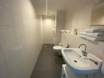 a white bathroom with a sink and a toilet at Greenstay in Amsterdam
