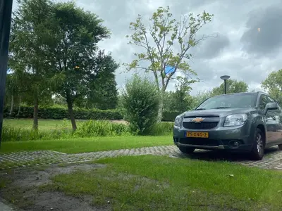 a green car parked in a parking lot at Greenstay in Amsterdam