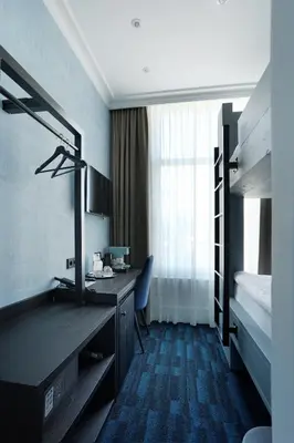 a hotel room with a desk and a bunk bed at De Ware Jacob Boutique Hotel in Amsterdam