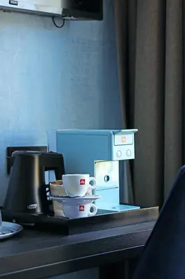 a table with a coffee maker and cups on it at De Ware Jacob Boutique Hotel in Amsterdam
