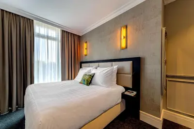 a hotel room with a bed and a window at De Ware Jacob Boutique Hotel in Amsterdam