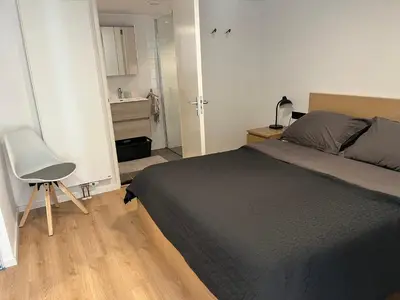 a bedroom with a bed and a desk and a chair at In The Heart of Zandvoort in Zandvoort