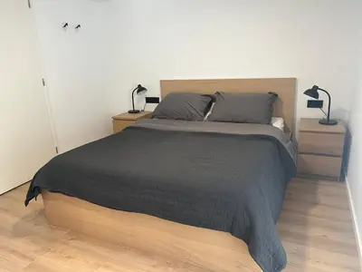 a bedroom with a large bed with two night stands at In The Heart of Zandvoort in Zandvoort